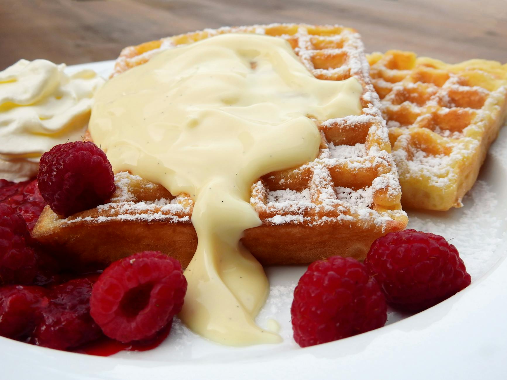 plate of waffles and raspberries